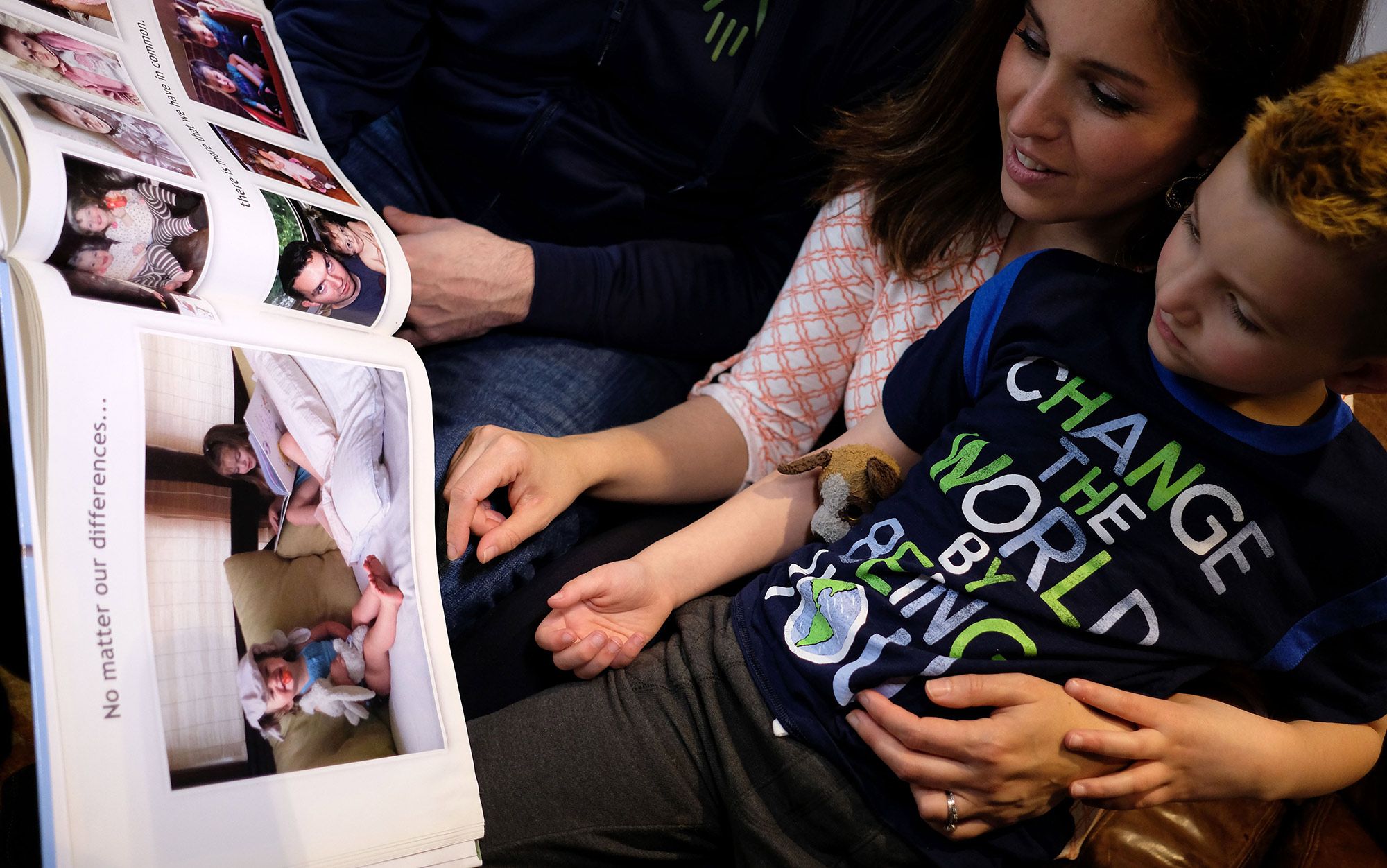 Jacob Lemay, aged 7, with his parents, looking through family photos from before his transition, Massachusetts, 2017. Photo by Jewel Samad AFP/Getty J